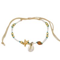 WHITE BEAD BRACELET WITH COWRIE SHELL AND SHELLS