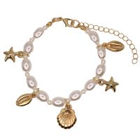 BR8299 PEARL BRACELET W/ GOLD MARINE CHARMS
